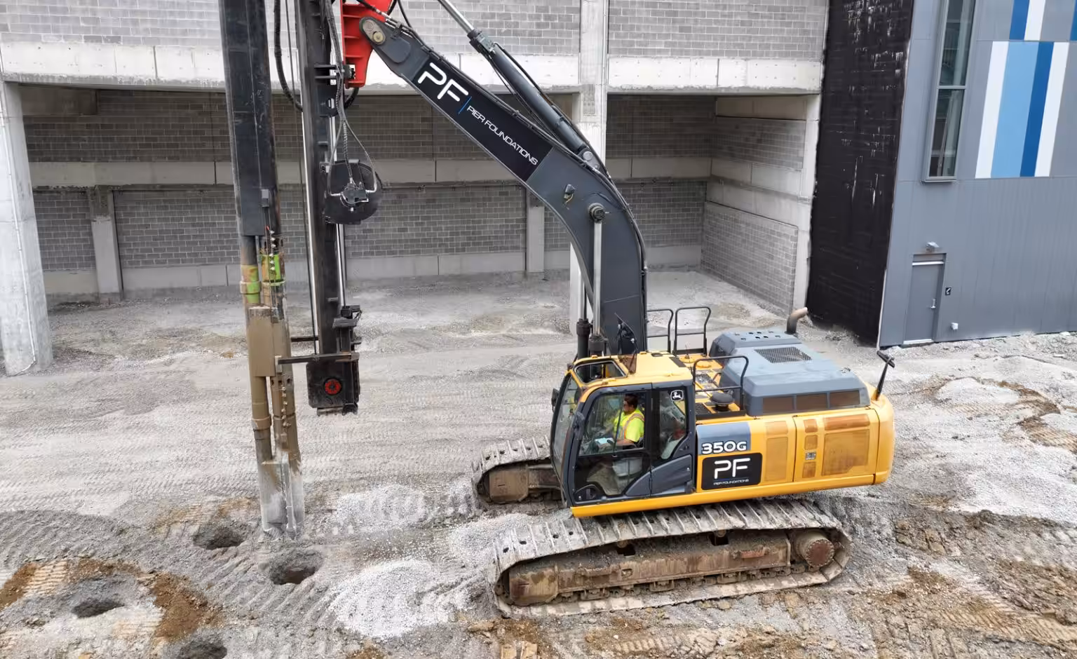 drill rig operating inside building foundation